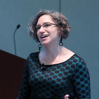 Dr. Briana Pobiner speaks to audience.