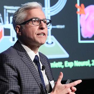 Kochanek speaks with slide projected behind him