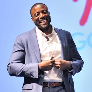 Christian stands smiling