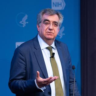 Collinge standing at podium