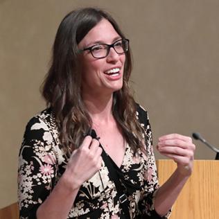 Dr. Wilson speaks at podium