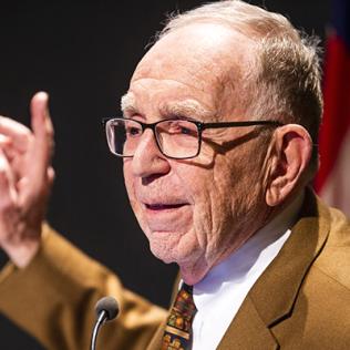 Dr. Edward Feigenbaum with raised hand