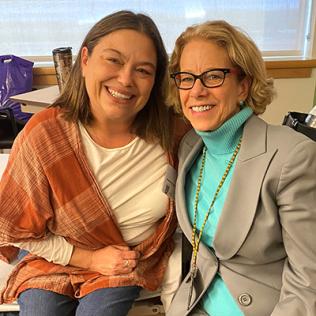 Murphy and Bianchi sit together smiling.