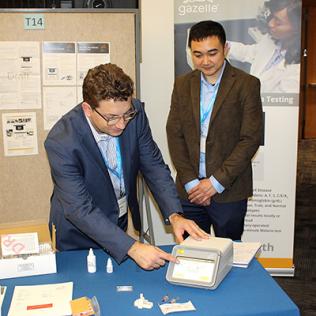 Two scientists examine device.