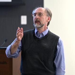 Dr. Giniger addresses audience.