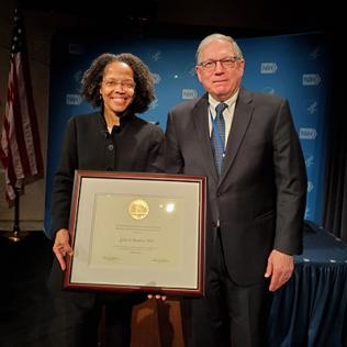 Dr. Tabak presents plaque to Dr. Barabino