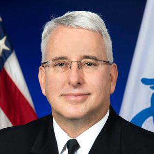 Rear admiral Richard Childs in front of the American flag