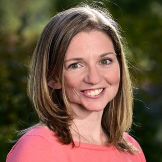 A smiling Cassandra Hayne standing outside 