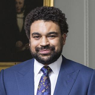 Portrait of Dr. Alexandre White, in museum in front of a painting