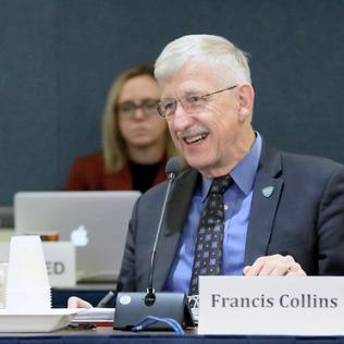Tabak and Collins smile, seated at the ACD meeting table