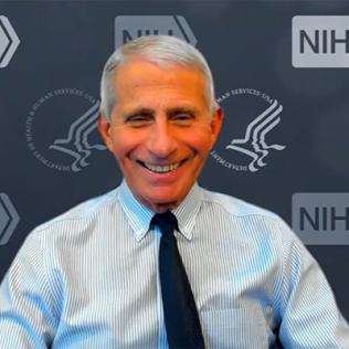 A smiling Fauci on Zoom in front of NIH/HHS backdrop