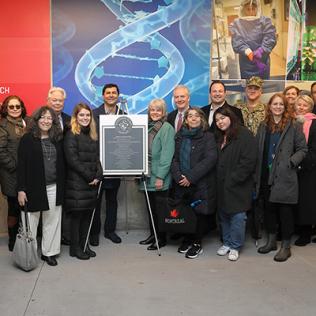 Representatives from several organizations smile into camera.