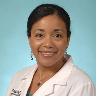 A smiling Dr. Rogers in white lab coat against pale blue background