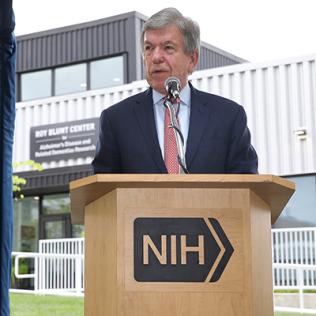 Blunt speaks at a podium