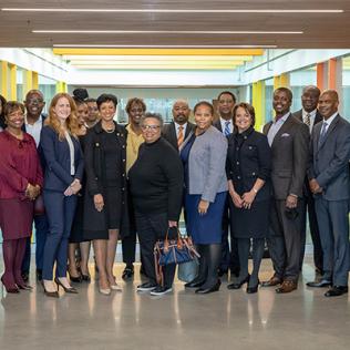 Large group of people smile into camera