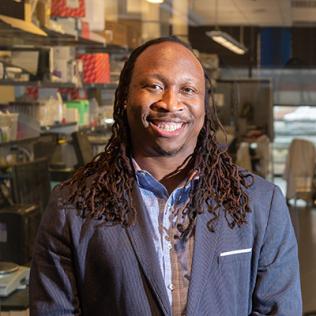Platt smiles, with lab behind him
