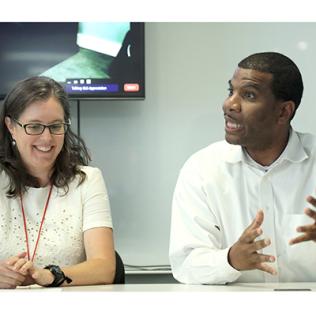 Alicia Livinski and Derek McDowell, seated at table