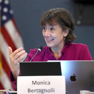 Woman gestures with hands as she speaks