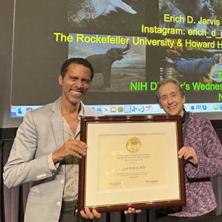 Jarivs accepts a plaque from Schor 