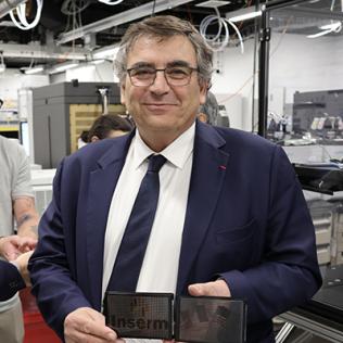 Samuel holding assay plates in a lab