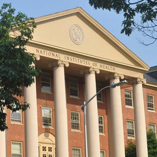 exterior of 3-story building with stone pillars and grand staircase
