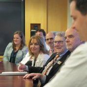 Katz sits at a conference table surrounded by several doctors