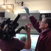 NCI’s Dr. John Wunderlich holds up plastic container of a patient's cells.NCI’s Dr. John Wunderlich holds up plastic container of a patient's cells.