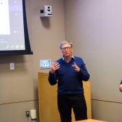 Gates chats with VR team members.