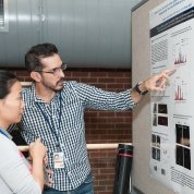 Alvarez-Prats discusses his poster with a passerby