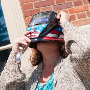 A woman looks up at the eclipse