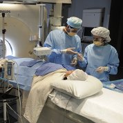 Doctors at the Clinical Center prepare to begin interventional radiology on a patient.