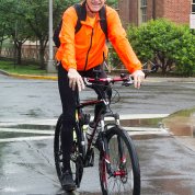 Dr. Francis Collins bicycles onto campus.