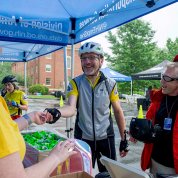 Cyclists collect their T-shirts and other event items.