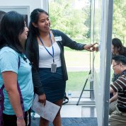 Two students discussing a poster.