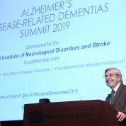 Dr. Koroshetz speaks in front of a screen.
