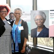 EDI's Victoria Gross poses with NIA's Dr. Marie Bernard next to Bernard's portrait at exhibit in Natcher,