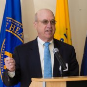 Gilman speaks in front of a podium