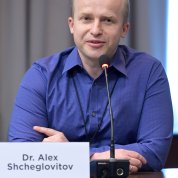 Shcheglovitov, seated, speaks into table mic.