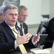 Seated, Droegemeier gestures while speaking
