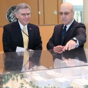 Gilman and Droegemeier stand behind a 3-D model of the hospital building
