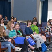 Dr. Tabak hosts a Jeopardy-style game with kids in Wilson Hall.