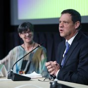  Shurtleff speaks at the symposium while Langevin looks on.