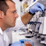 A researcher inserts a gene chip into a machine.