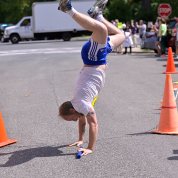 A runner cartwheels over the finish line