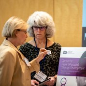 Two women speak to each other