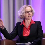 Dr. Volkow, seated on panel, holds up her hand.