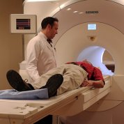 Technologist talks to patient in a scanner.