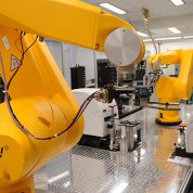 Robotic arms moving trays of samples into testing machines.