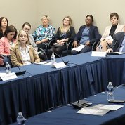 Several members sit at a conference table