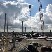 Workmen accept loads on roof.